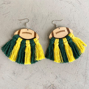 Macrame football tassel earrings in green and yellow with wooden football tops.