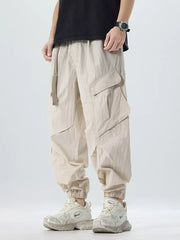 Oversized khaki cargo pants with adjustable belt and multiple pockets.