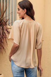 Relaxed V-neck blouse in Tan with cap sleeves and gathered neckline detail.