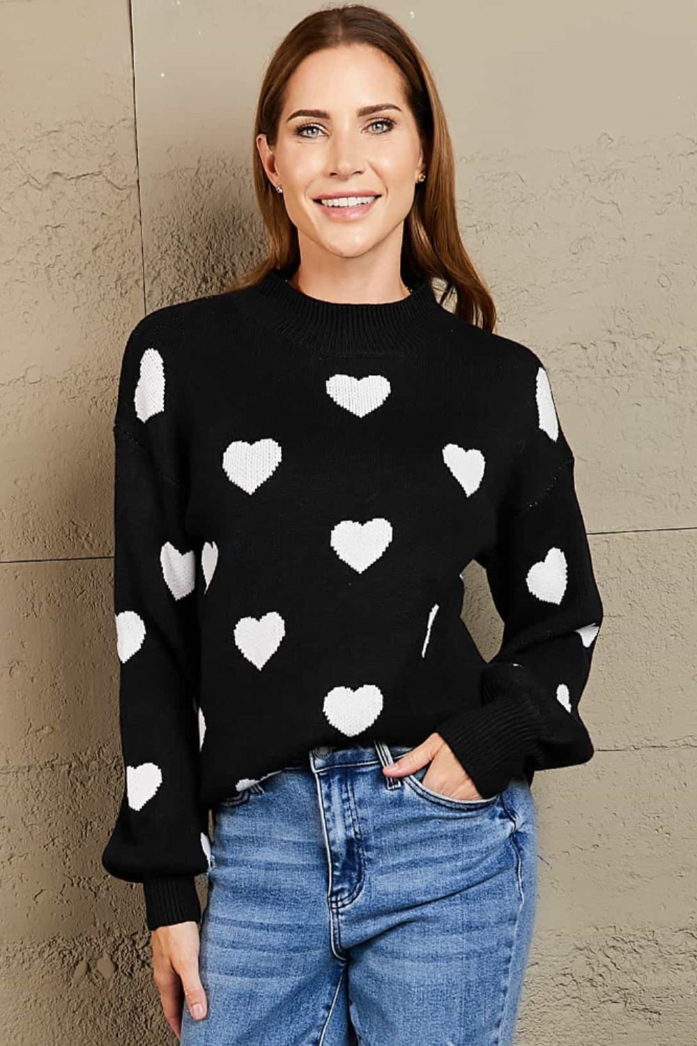 Black sweater with white hearts, mock neck, and balloon sleeves.