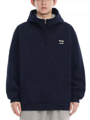 Navy blue quarter-zip hoodie with a small embroidered patch that says "BELIEVE IN ME".