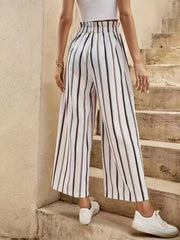 High-waisted palazzo pants with black and white vertical stripes and a cinched waist.
