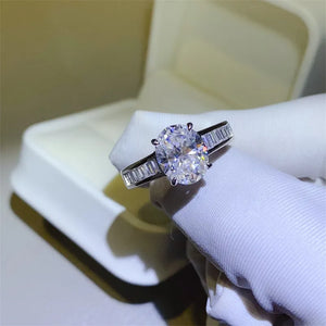 Silver oval cut diamond ring with baguette side stones.
