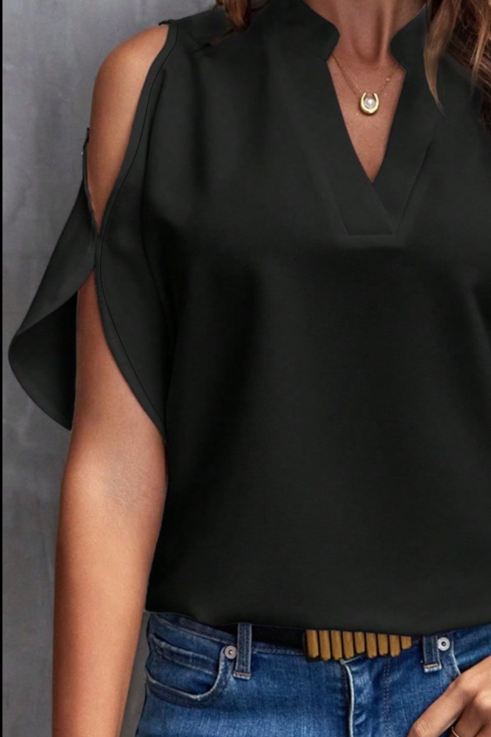Black polyester open-shoulder blouse with keyhole neckline and flutter sleeves.