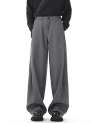 Men's dark gray flowy wide-leg sweatpants with button closure and a relaxed fit.