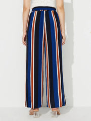 Striped palazzo trousers with side slits in blue, black, white, and rust.