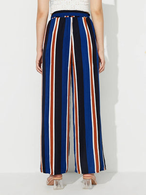 Striped palazzo trousers with side slits in blue, black, white, and rust.