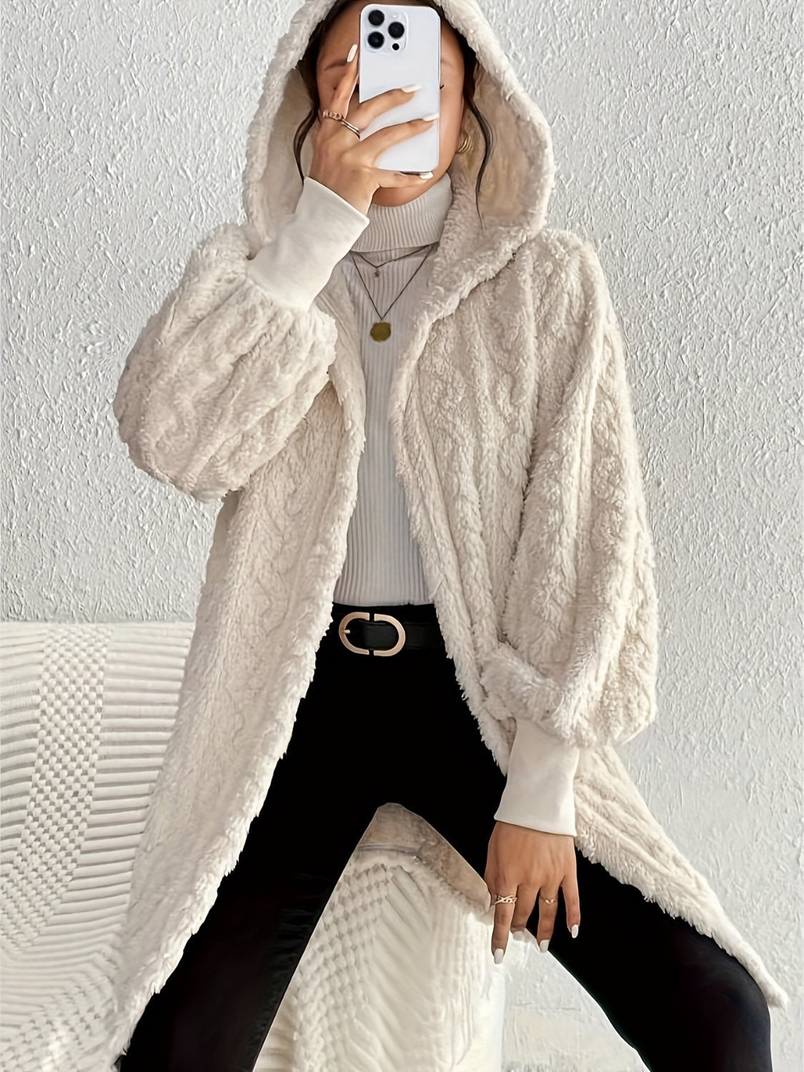 Beige textured cable knit hooded cocoon coat with balloon sleeves.