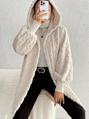 Beige textured cable knit hooded cocoon coat with balloon sleeves.