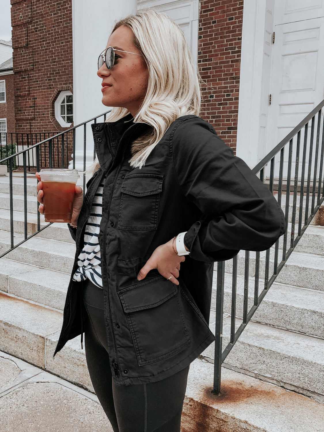 Black utility field jacket with multiple pockets and a stand-up collar.