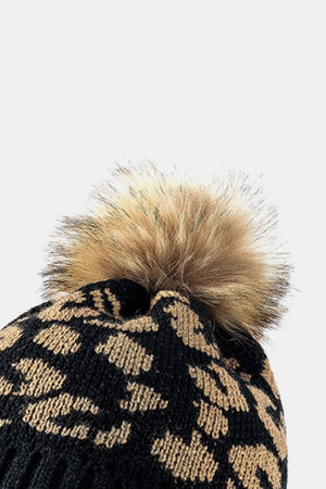 Black acrylic beanie with leopard print and faux fur pom.