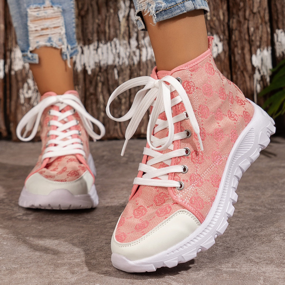 Pink canvas lace-up high-top sneakers with white toe cap and chunky sole.