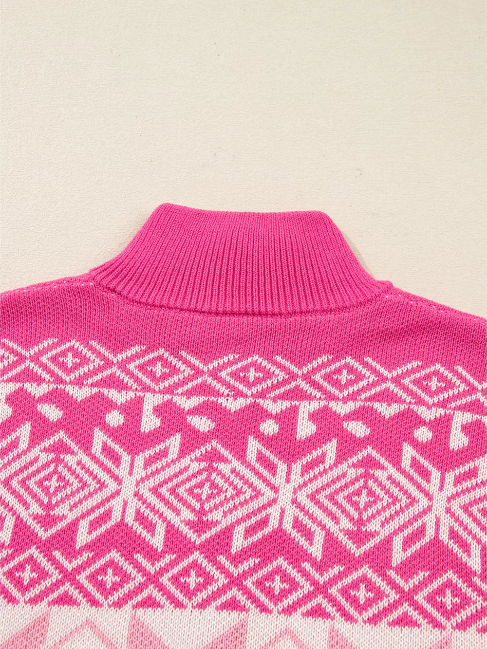 Pink knit quarter zip sweater with white Fair Isle pattern and mock neck.