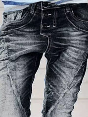 Dark blue cuffed button-fly jeans with a distressed wash and white stitching.