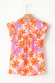 Multicolor floral blouse with smocked bodice, ruffled neckline and flutter sleeves.
