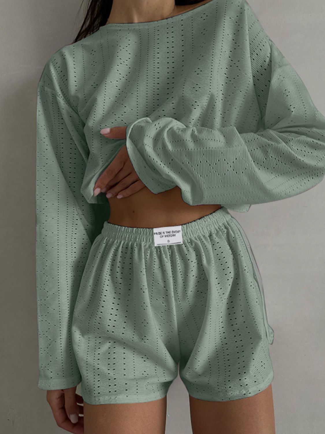 Matcha green perforated crop top and shorts set with a relaxed fit.