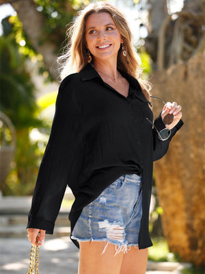 Black oversized linen beach shirt with button front and tie detail, styled with denim shorts.