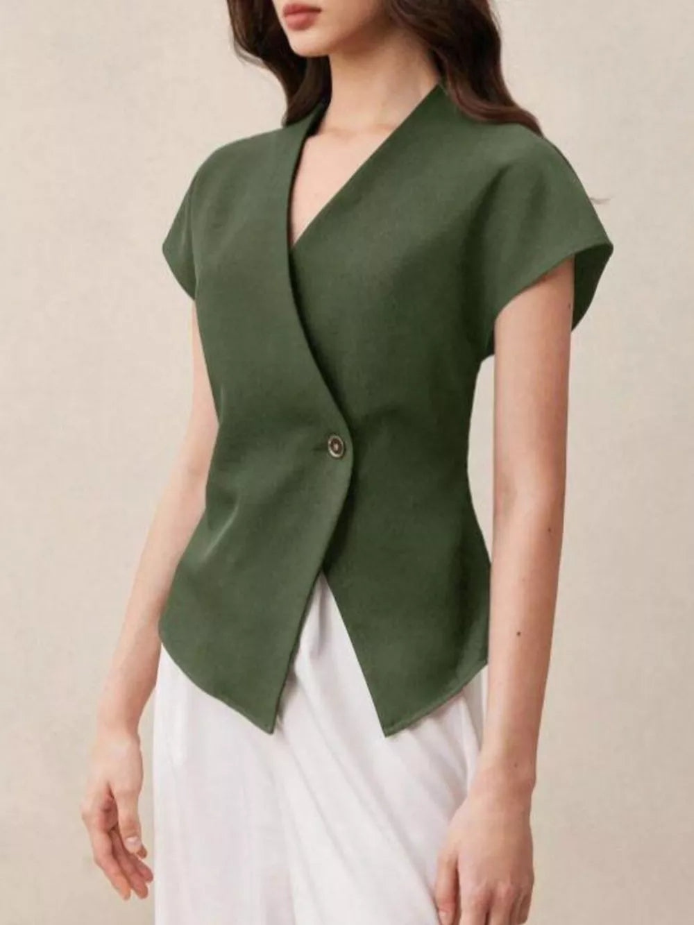 Chic asymmetrical wrap shirt in olive green with cap sleeves and a single button closure.