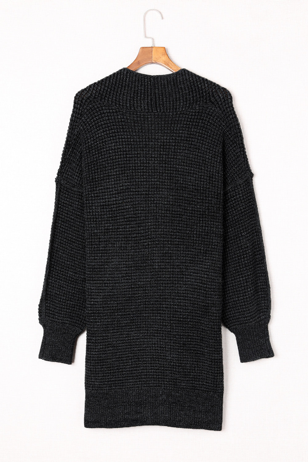 Black textured puff sleeve open cardigan with a ribbed knit and relaxed fit.