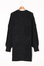 Black textured puff sleeve open cardigan with a ribbed knit and relaxed fit.