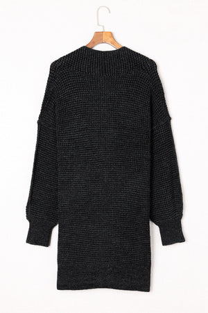 Black textured puff sleeve open cardigan with a ribbed knit and relaxed fit.