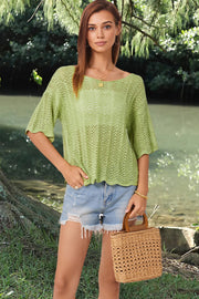 Light green open-knit blouse with scalloped sleeves and a boat neckline.