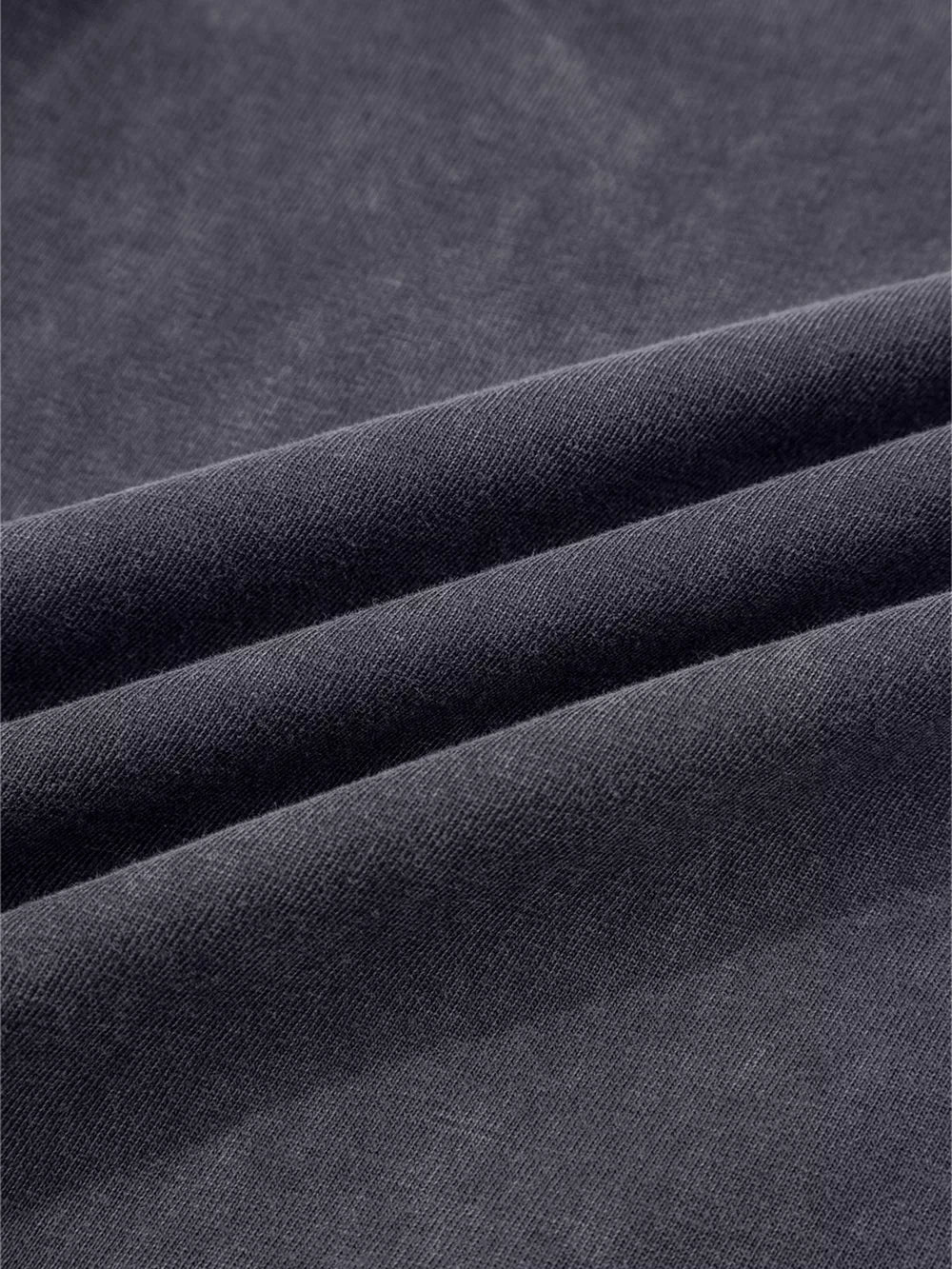 Dark grey cotton maternity trousers with a textured, washed finish and wide-leg cut.