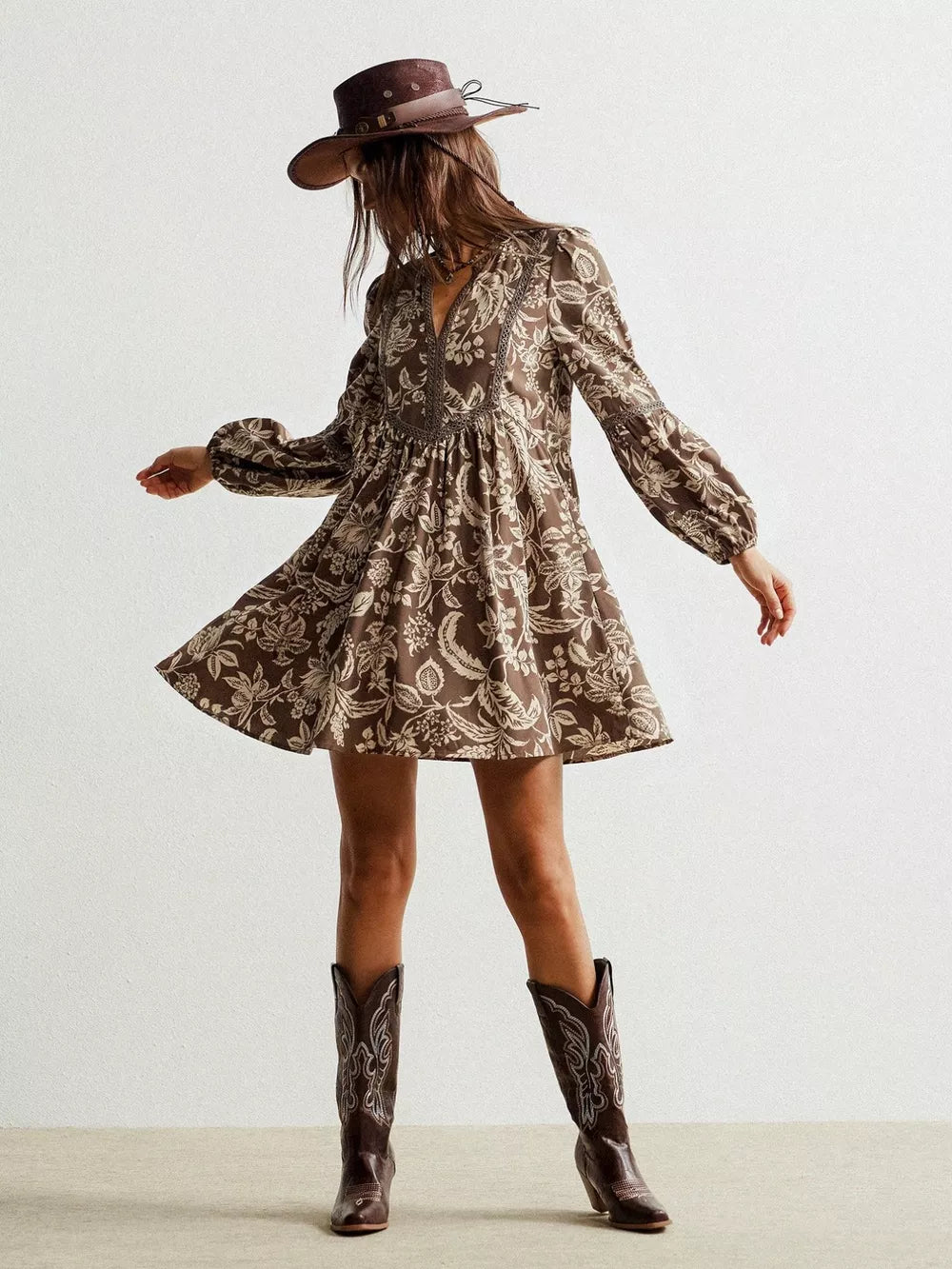 Brown floral print long sleeve dress with balloon sleeves and a notched neckline.