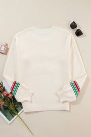 Ivory knit sweater with striped cuffs, crew neck, and long sleeves.