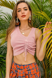 Blush pink ribbed crop top with gathered front and drawstring detail, V-neck, sleeveless.