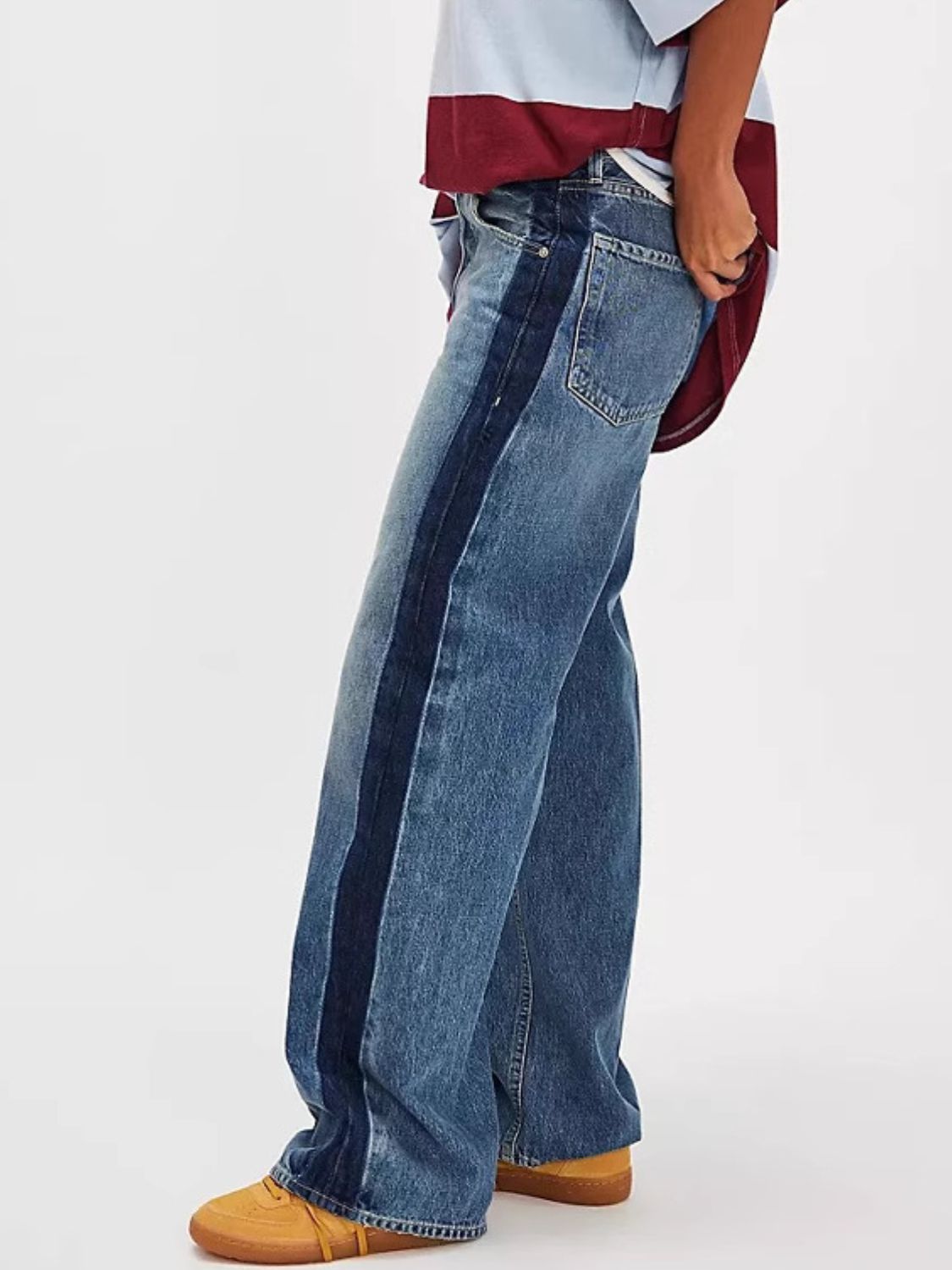 Dusty blue wide-leg jeans with a dark blue contrast side panel and button fly.