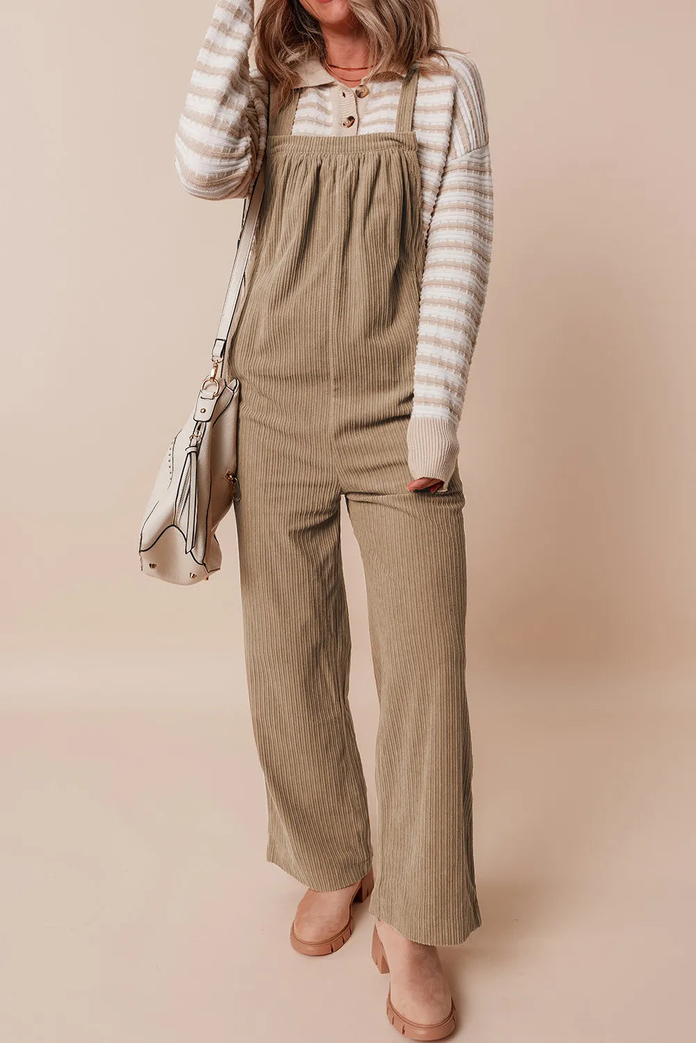 Camel corduroy wide-leg overalls with a bib front and adjustable straps.