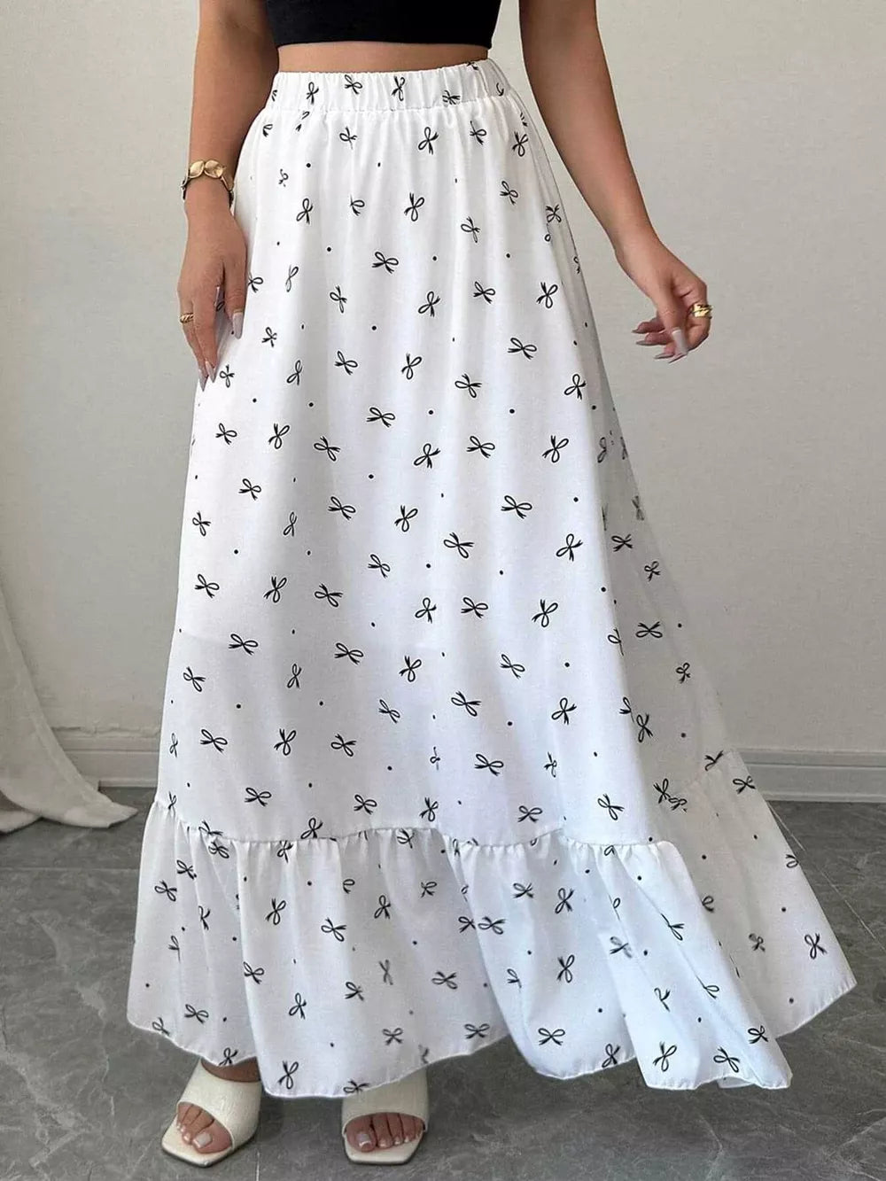 White maxi skirt with black bowknot print and ruffled hem