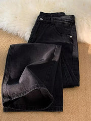Men's black vintage wash wide-leg jeans with a folded hem detail.