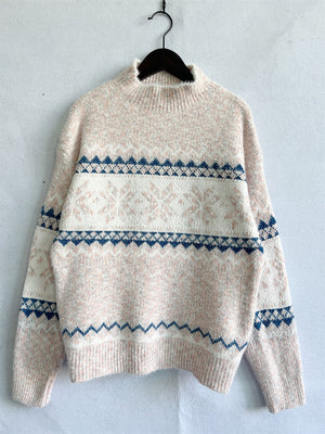 Geometric knit mockneck pullover in pastel yellow with navy and white pattern.