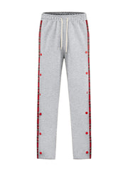 Light gray sweatpants with plaid snap-button trim and drawstring waist.