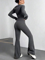 Dark gray ribbed knit flare set outfit with a hooded top and high-waisted flared pants.