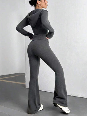 Dark gray ribbed knit flare set outfit with a hooded top and high-waisted flared pants.