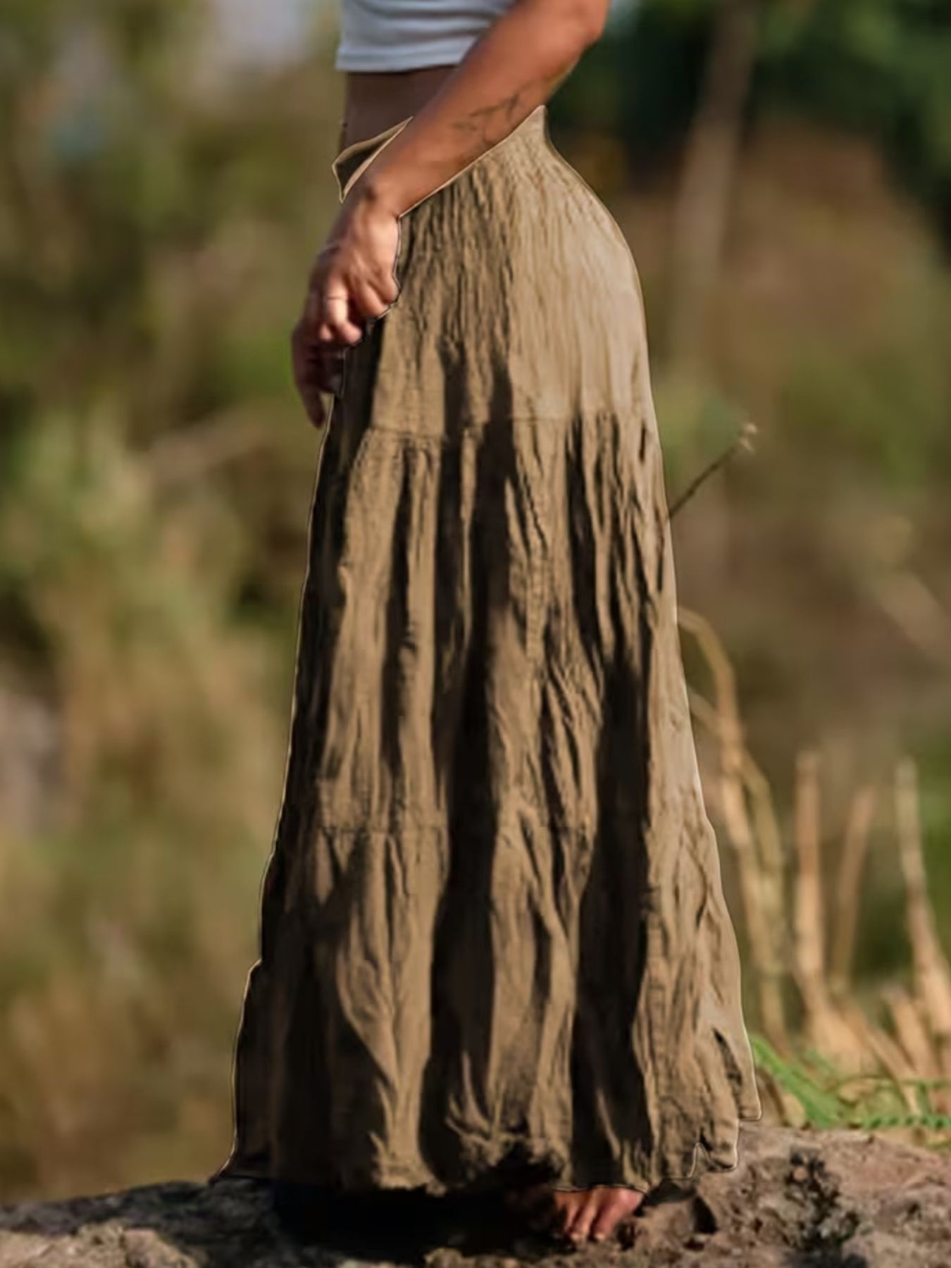 Khaki tiered maxi skirt with a flowing bohemian cut and crinkled texture.