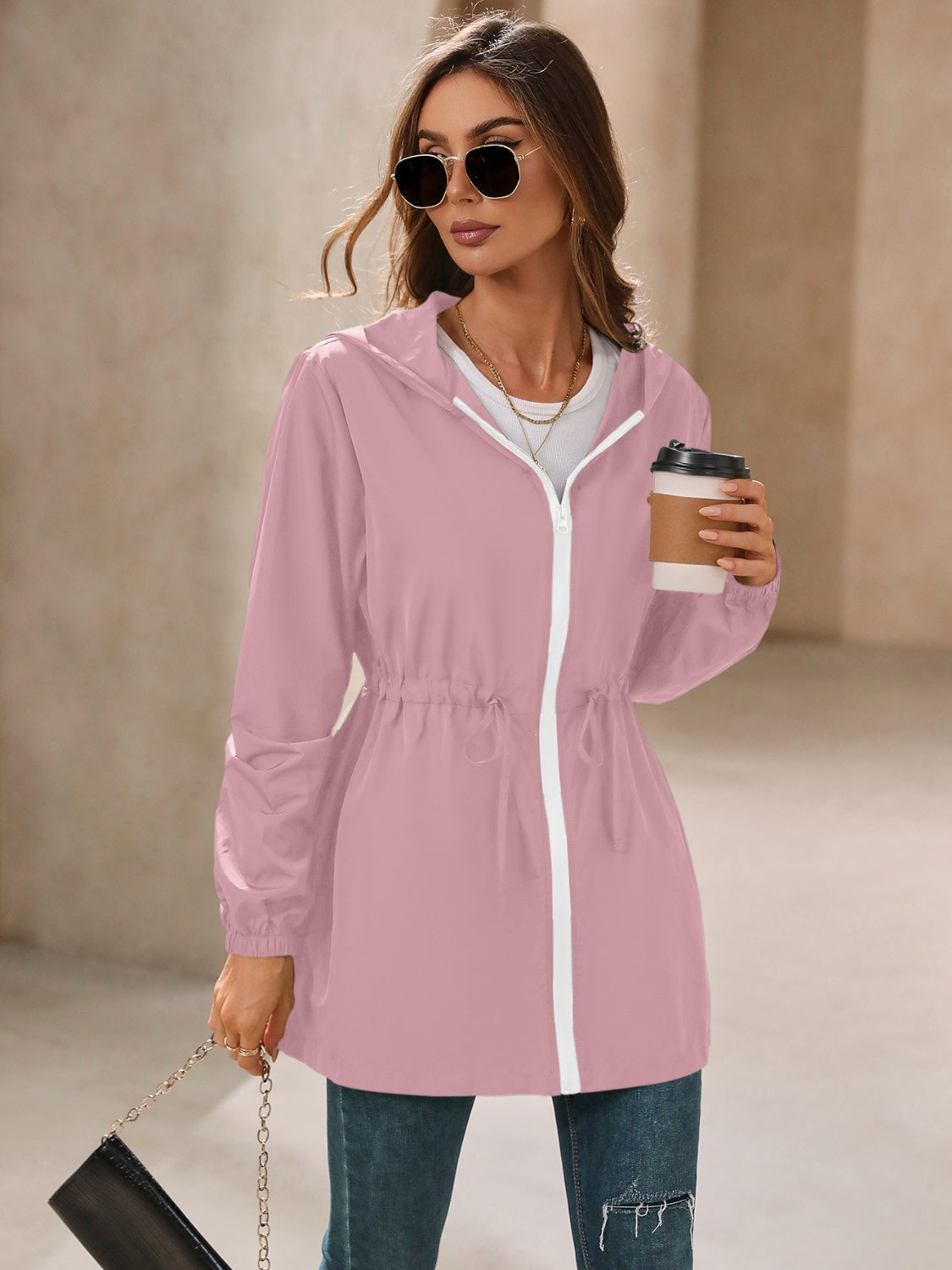 Dusty Pink hooded jacket with cinched waistline and white zipper detail.