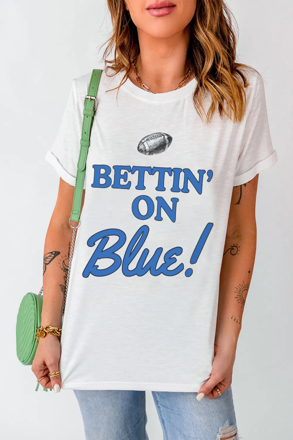 White graphic t-shirt with blue text that says "Bettin' On Blue!" and a football graphic.