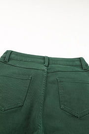 Green cotton straight-leg jeans with crossed v-waist detail and back pockets.