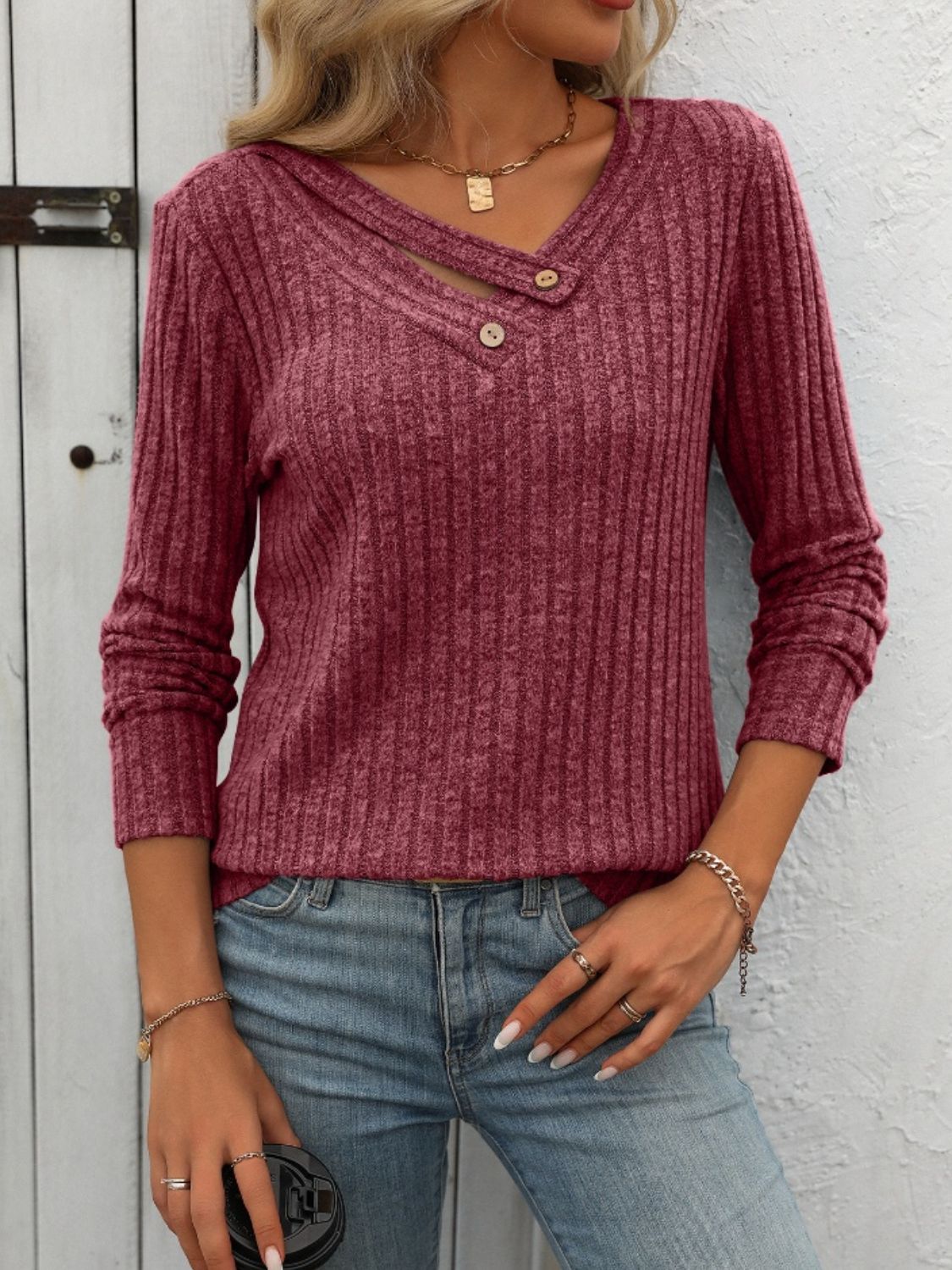 Burgundy ribbed knit henley top with keyhole neckline and button detail.