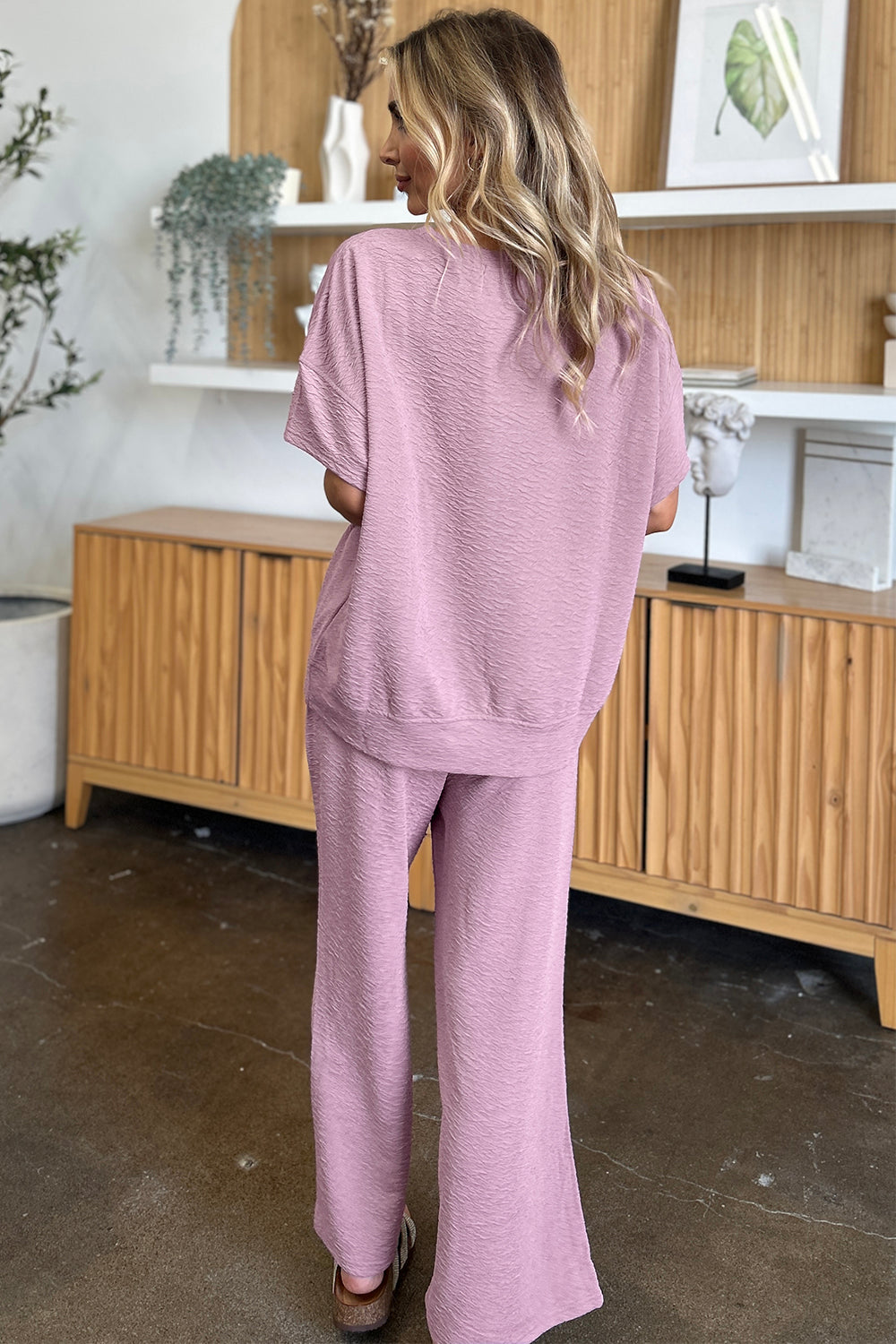 Textured cocoon top and wide leg pants set in dusty pink, back view