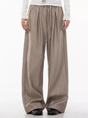 Khaki wide-leg pleated trousers with pinstripes and drawstring waist.