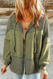 Colorblock knit zip-up hoodie in olive green with textured panels and a drawstring hood.