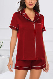 Scarlet satin pajama set with white piping, button front top and shorts.