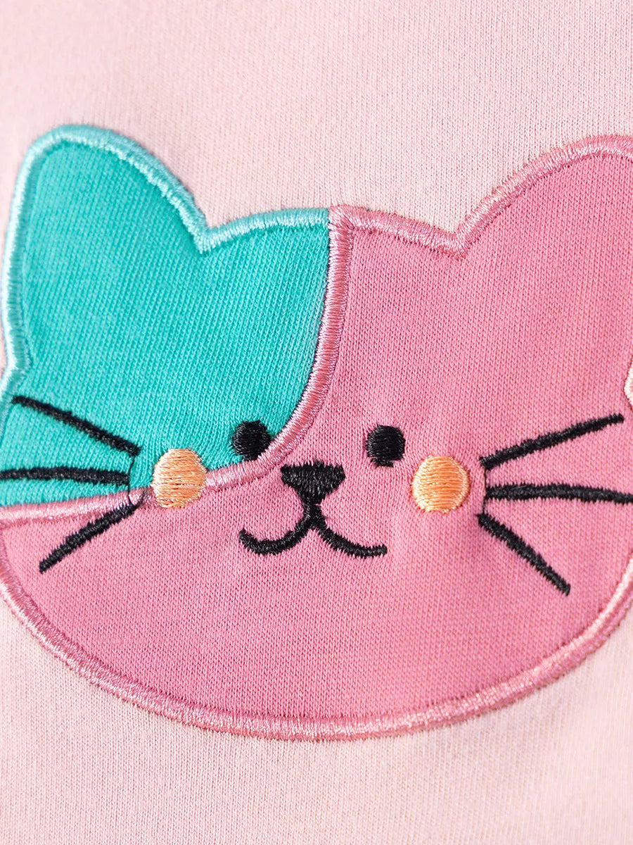 Children's pink dress with a two-tone embroidered cat face detail.