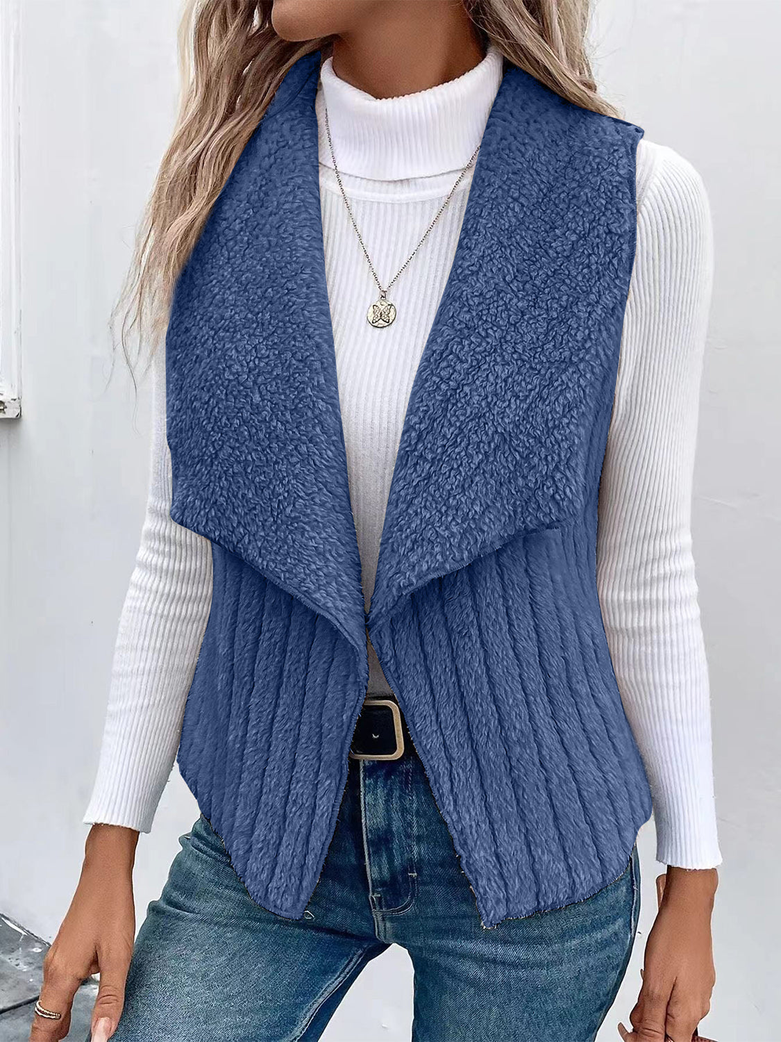 Textured teddy collarless vest in Dusty Blue with ribbed detail and open front.