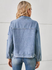 Light wash denim trucker jacket with distressed details and button cuffs.